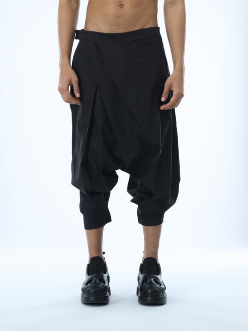 Junus Coban men’s wide pleated drop-crotch capri pants in black front view
