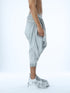 Detail of grey wide pleated men’s capri pants by Junus Coban
