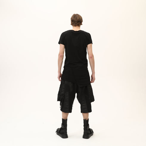 Back view of men’s black asymmetric raw seam T-shirt with bold Junus Coban streetwear styling.