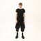Front view of men’s black asymmetric raw seam T-shirt with uneven hem and avant-garde streetwear styling.