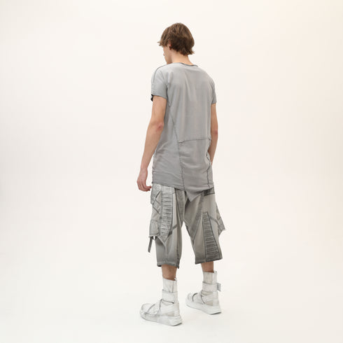 Back angle view of men’s grey asymmetric raw seam T-shirt with layered raw seam detail.