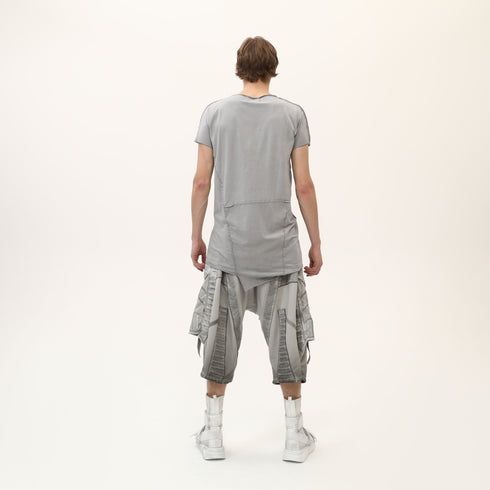 Back view of men’s grey asymmetric raw seam T-shirt with irregular hem and relaxed streetwear fit.