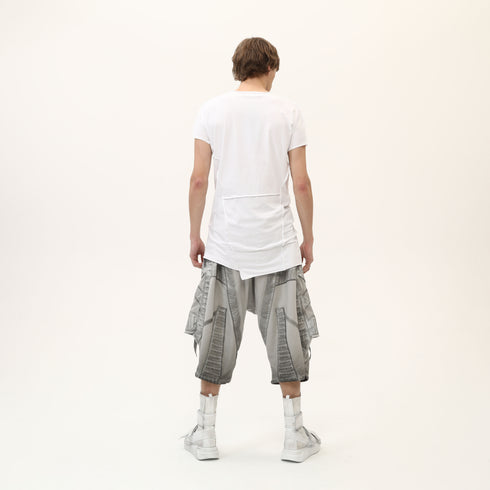 Back view of men’s white asymmetric raw seam T-shirt with irregular hem and Junus Coban attitude.