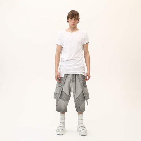 Front view of men’s white asymmetric raw seam T-shirt with uneven hem and clean streetwear styling.