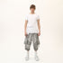 Front view of men’s white asymmetric raw seam T-shirt with uneven hem and clean streetwear styling.