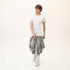 Full styling view of men’s white asymmetric raw seam T-shirt for festival and streetwear looks.