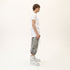 Side profile of men’s white asymmetric raw seam T-shirt with short sleeves and regular fit.