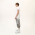Side profile of men’s white asymmetric raw seam T-shirt with short sleeves and regular fit.