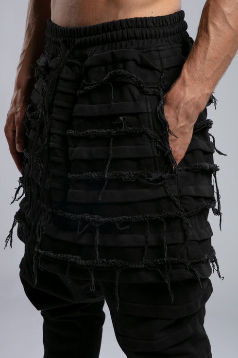 Junus Coban Men's Denim Detail Pants in Acid Black detail view showing distressed layered panel texture