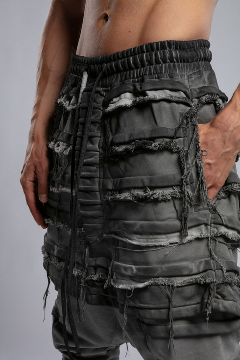 Junus Coban Men's Denim Detail Pants in Acid Grey detail view showing distressed layered panel texture