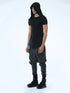 Angle view of men’s black hooded T-shirt showing pleated front detail, shoulder accents and long curved hem.