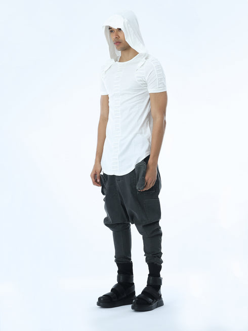 Angle view of men’s white hooded T-shirt showing pleated front detail, shoulder accents and long curved hem.