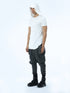 Angle view of men’s white hooded T-shirt showing pleated front detail, shoulder accents and long curved hem.