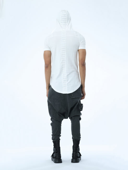 Back view of men’s white hooded multi-pleated T-shirt with long curved hem and Junus Coban streetwear attitude.