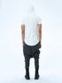 Back view of men’s white hooded multi-pleated T-shirt with long curved hem and Junus Coban streetwear attitude.