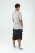 Back angle view of men’s grey paneled T-shirt with raw seam construction and Junus Coban streetwear attitude.