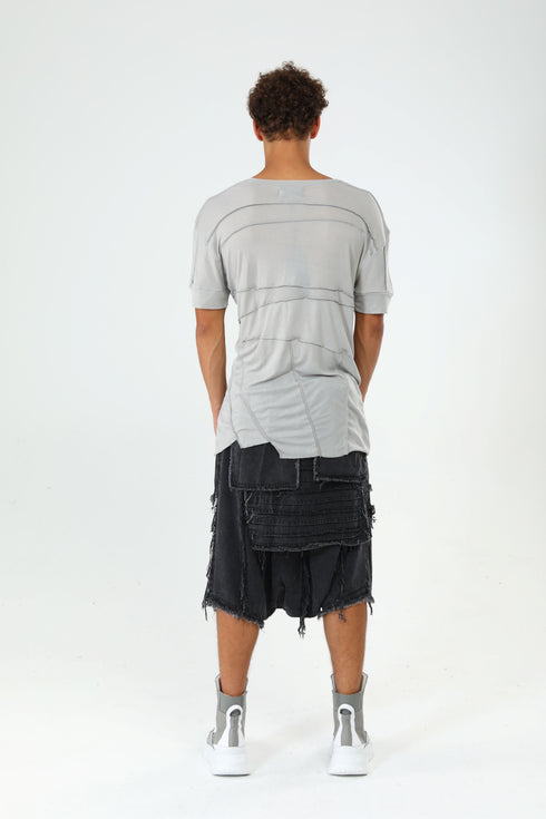 Back view of men’s grey paneled raw seam T-shirt showing layered seam details and long regular fit.