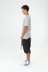 Side view of men’s grey paneled raw seam T-shirt with short sleeves and avant-garde streetwear styling.
