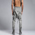 Back view of men’s anthracite piped raw stitch shalwar pants with avant-garde drop-crotch construction.