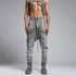 Close front view of men’s anthracite shalwar pants showing raw stitch details, piped trims and drawstring waist.