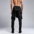 Back view of men’s black piped raw stitch shalwar pants with relaxed drop-crotch construction.