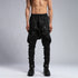 Close front view of men’s black shalwar pants showing piped trim, raw stitch details and adjustable drawstring waist.