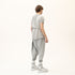 Back side view of men’s anthracite raw seam T-shirt with sculptural shoulder detail and streetwear silhouette.