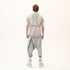 Back view of men’s anthracite raw seam T-shirt with relaxed fit and textured avant-garde details.