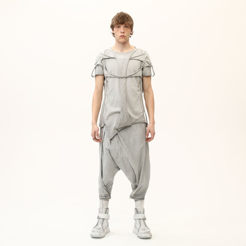 Front full look of men’s anthracite raw seam avant-garde T-shirt styled with drop-crotch pants.