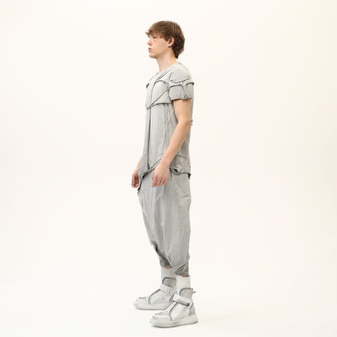Side view of men’s anthracite raw seam T-shirt with sculptural shoulder detail and relaxed fit.