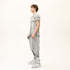 Side view of men’s anthracite raw seam T-shirt with sculptural shoulder detail and relaxed fit.