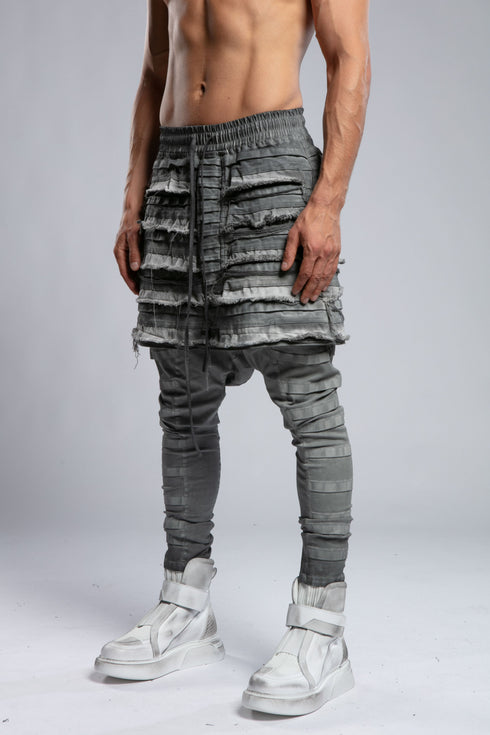 Junus Coban Men's Ribbed Raw Seam Pants in Grey side view showing tapered ribbed leg and dropped shape