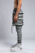 Junus Coban Men's Ribbed Raw Seam Pants in Grey three-quarter front view with sculptural layered texture