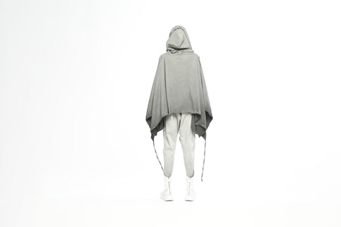 Back silhouette of architectural grey tunic by Junus Coban