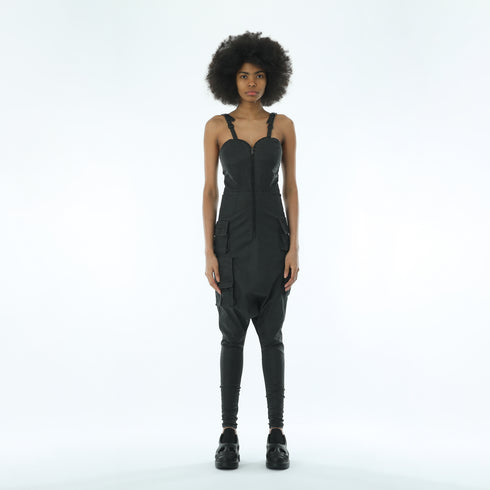 Back view of women’s black strapless drop-crotch jumpsuit with adjustable shoulder straps and slim lower-leg fit.