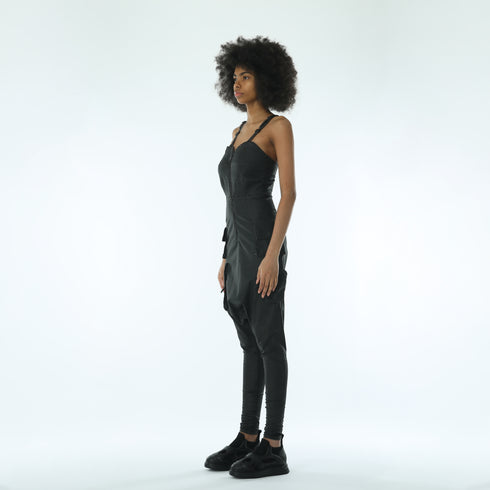 Side view of women’s black strapless jumpsuit with drop-crotch silhouette, side pocket details and avant-garde streetwear styling.