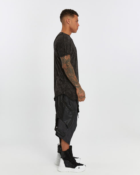 Men's Raw Seam T-shirt in Acid Black profile view with pointed front hem