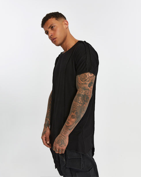 Men's Raw Seam T-shirt in Black angled view showing exposed seam lines