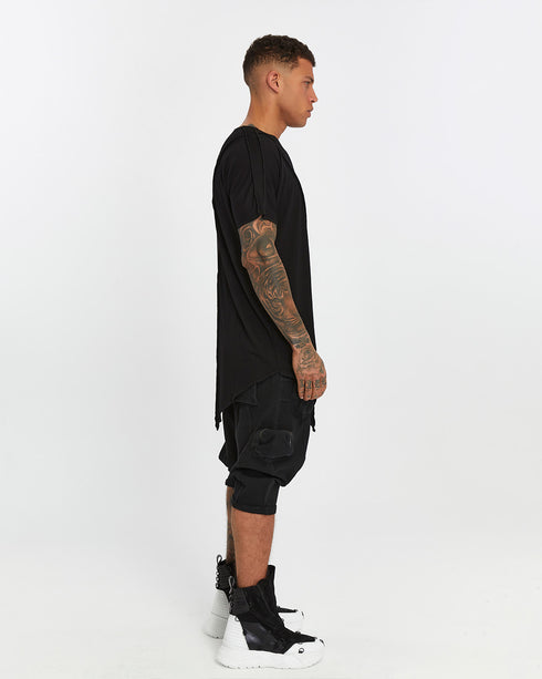 Men's Raw Seam T-shirt in Black profile view with pointed front hem
